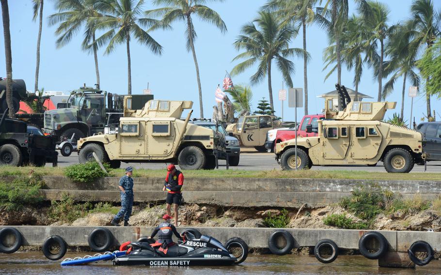 Crew members from the Navy and Honolulu Ocean Safety & Lifeguard Services speak briefly at Haleiwa Boat Harbor regarding the search for 12 Marine aviators off the North Shore of Oahu, Jan. 16, 2016. The Coast Guard and several partner agencies are continuing the search after the notification of two downed military helicopters, each reportedly with six personnel aboard, Jan. 14, 2016.