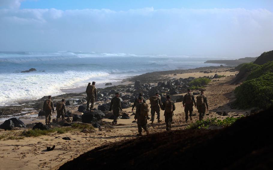 U.S. Marines assigned to 3rd Squad, 1st Platoon, 2nd Battalion, 3rd Marine Regiment, search for debris of two CH-53E Super Stallion helicopters along the coast of Haleiwa, Hawaii, Jan. 16, 2016. The Marines with 2nd Battalion, 3rd Marines are covering the whole north point of the island to determine the field of dispersion of the debris.