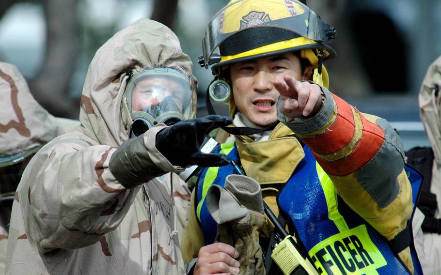 An emergency response team member from Naval Branch Health Clinic Sasebo, left, discusses tactics with a Japanese firefighter during a mass casualty drill as part of a Keen Edge exercise at Fleet Activities Sasebo, Japan, Feb. 1, 2007. Keen Edge is an annual bilateral command-post exercise that uses computer simulations to prepare U.S. and Japanese servicemembers to effectively defend Japan or respond to a regional crisis. This year's exercise is scheduled to run Jan. 23-29, 2016, at venues throughout Japan and Hawaii.
