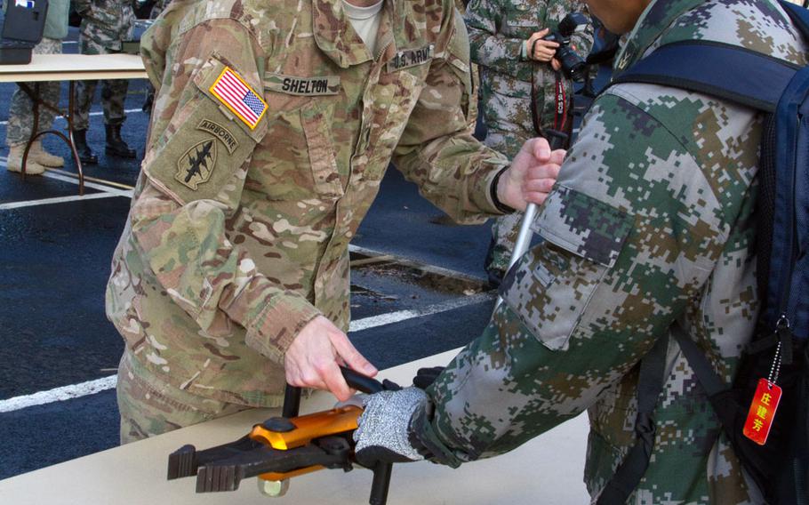 Lt. Col. Jason Shelton, plans officer, I Corps, gets some hands-on learning on the use of some of the machinery used by soldiers in the People’s Republic of China People’s Liberation Army during emergency and disaster relief efforts at the Disaster Management Exchange held at Joint Base Lewis-McChord Nov. 16-21, 2015.