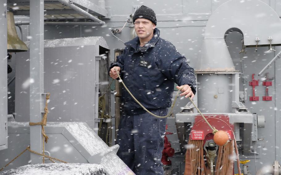 A crewmember from USS Patriot stows a heaving line in a locker aboard the mine-countermeasures ship in Otaru, Japan, on Thursday, Feb. 4, 2016. The Avenger-class mine-countermeasures ship from Sasebo, Japan is making its third visit to Hokkaido in the 20 years.

