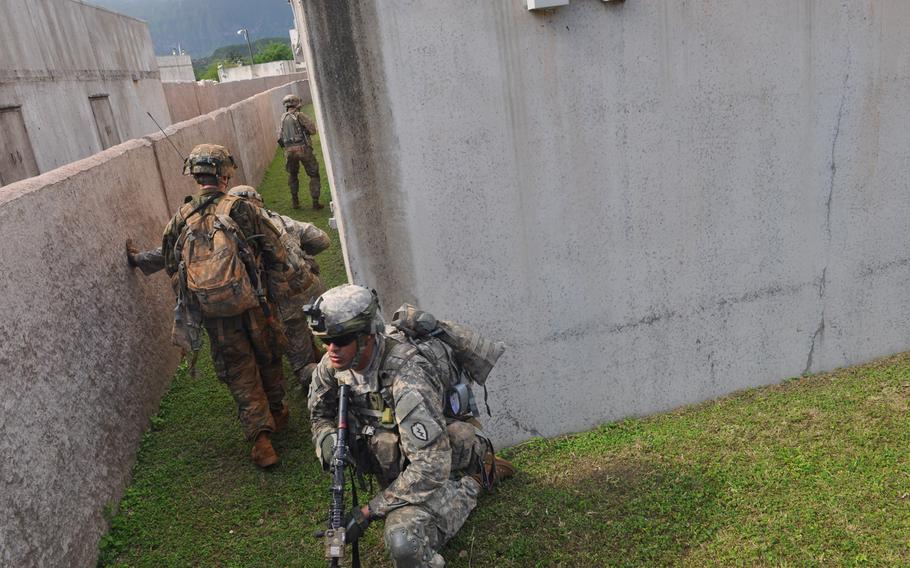 Soldiers make their way through a labyrinth of alleys in a town held by terrorists during a mock raid as part of Exercise Lightning Forge, Feb. 5, 2016, at Marine Corps Training Area Bellows, Hawaii.

Wyatt Olson
Stars and Stripes