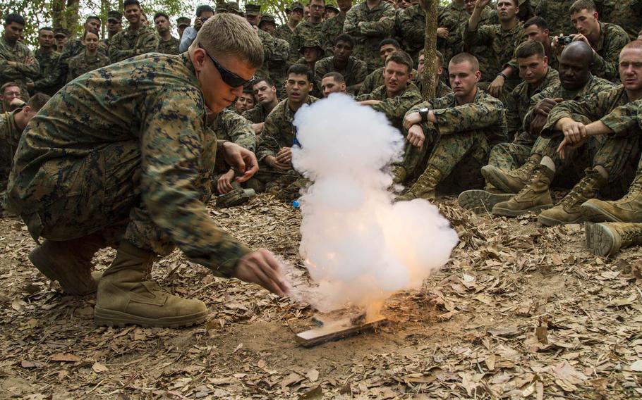 A Marine uses brake fluid and gunpowder to create a fire at a jungle survival class during Cobra Gold 2014. A scaled-down version of the annual exercise, one of the world's largest multinational military events, kicks off Tuesday, Feb. 9, 2016, in Thailand.