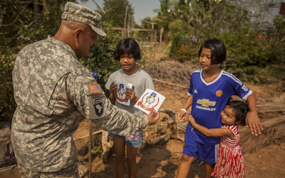 A U.S. soldier passes out exercise stickers to Thai children during Cobra Gold 2016, in Lop Buri, Thailand. Elements of several Army brigades will deploy for a dozen exercises, including Cobra Gold, across the Pacific this year as part of a program designed to boost the service's engagement in the region.