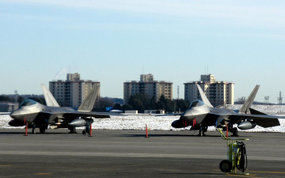 F-22 Raptors wait on a ramp at Yokota Air Base, Japan Thursday.