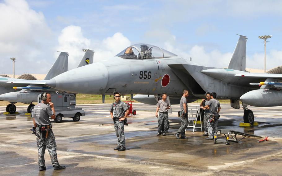 A maintenance crew readies a Japan Air Self-Defense Force F-15 fighter jet for Cope North training, Wednesday, Feb. 17, 2016, at Andersen Air Force Base, Guam. Aircraft from the U.S. Air Force and Navy, Japan and Australia are being used for the disaster-relief and combat-readiness drills, which kicked off last week and run through Feb. 26.