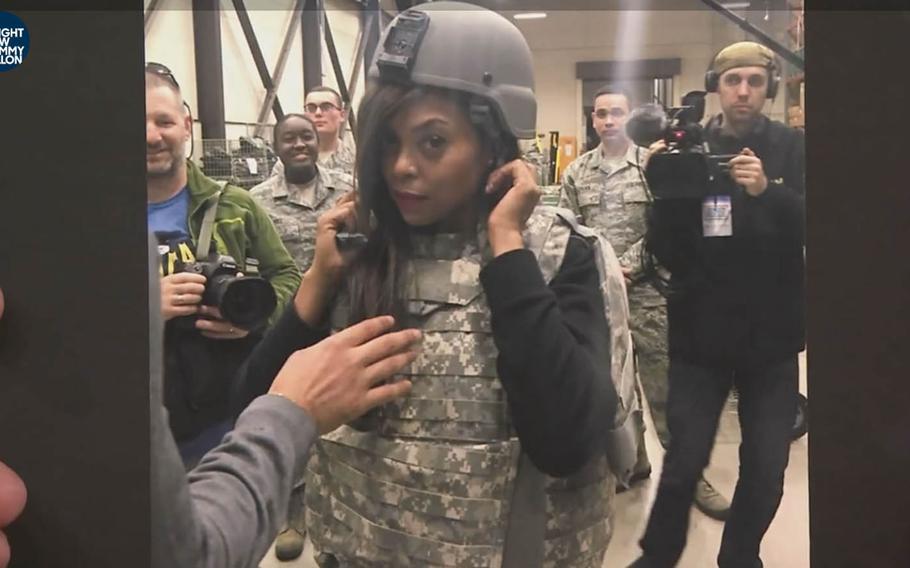 "Tonight Show" host Jimmy Fallon shows a photo of "Empire" star Taraji P. Henson decked out in military gear at Yokota Air Base, Japan, during a December USO tour.