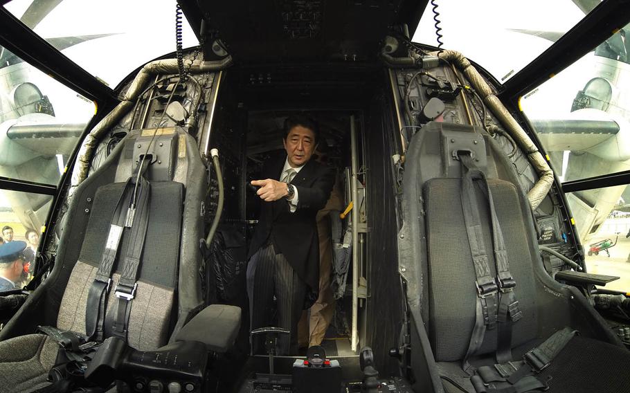 Japanese Prime Minister Shinzo Abe explores an MV-22B Osprey from 3rd Marine Expeditionary Force on Okinawa.