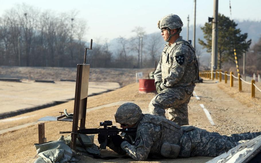 Staff Sgt. Lyle Begay (standing) assigned to Company B, 2nd Battalion, 3rd Infantry Regiment, 1-2 Stryker Brigade Combat Team, acts as a safety while Spc. Juan Herrera fires his weapon during rifle zeroing March 2, 2016, at Story Live Fire Complex, South Korea. Company B was in Korea to participate in Foal Eagle 2016, a bilateral exercise intended to increase readiness and strengthen Korea - U.S. relations. It is also the second exercise of Operation Pacific Pathways for 1-2 SBCT.