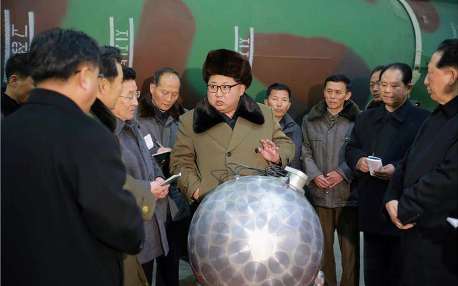 North Korean newspaper Rodong Sinmun on Wednesday published this front-page photo of leader Kim Jong Un posing with a silver ball that purportedly is a miniaturized nuclear bomb in front of what appears to be a missile. 