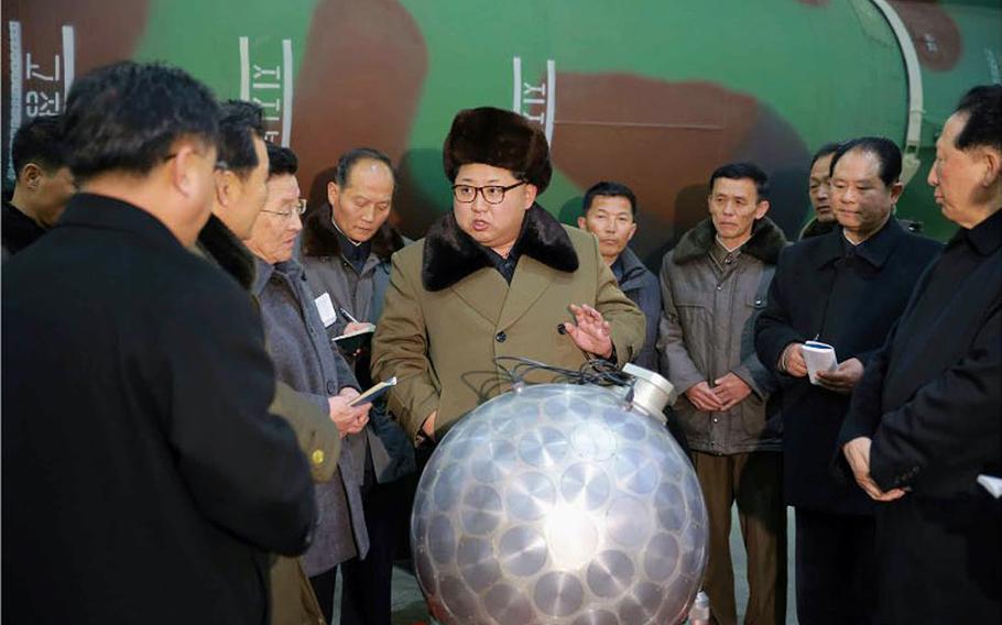 North Korean newspaper Rodong Sinmun on Wednesday published this front-page photo of leader Kim Jong Un posing with a silver ball that purportedly is a miniaturized nuclear bomb in front of what appears to be a missile.