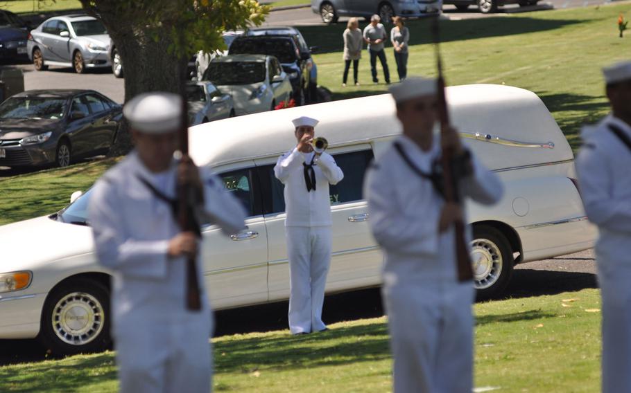 A bugler plays taps during a funeral held March 9, 2016, for Petty Officer 1st Class Vernon T. Luke, a  USS Oklahoma crew member, at the National Memorial Cemetery of the Pacific in Honolulu.