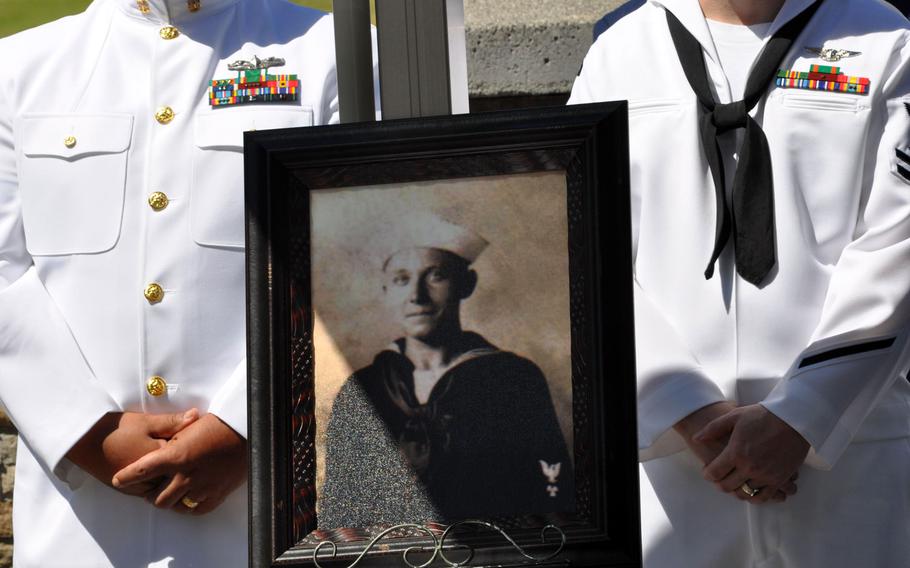 A photograph of Petty Officer 1st Class Vernon T. Luke, a  USS Oklahoma crew member, is displayed at a funeral held March 9, 2016, at the National Memorial Cemetery of the Pacific in Honolulu.