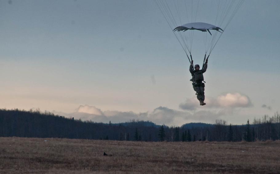 A paratrooper with U.S. Army Alaska's 4th Infantry Brigade Combat Team, 25th Infantry Division descends after performing a proficiency jump at Joint Base Elmendorf-Richardson, Alaska, March 26, 2015. Plans announced in July to cut 2,600 soldiers from the unit hae been delayed, officials said.