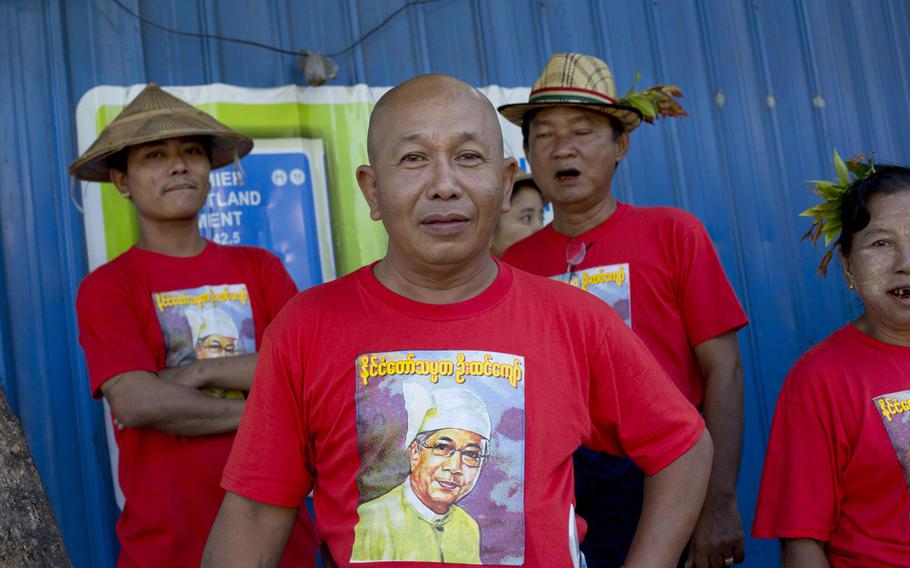 Supporters of the National League for Democracy party wearing T-shirts featuring new President Htin Kyaw wait to cross a main road to go to Buddhist monastery for praying, in Yangon,  Myanmar, Thursday, March 31, 2016. The party of Aung San Suu Kyi submitted a proposal to parliament on Thursday to create a new position for her as "state adviser," which would allow her to have a powerful hand in running Myanmar.