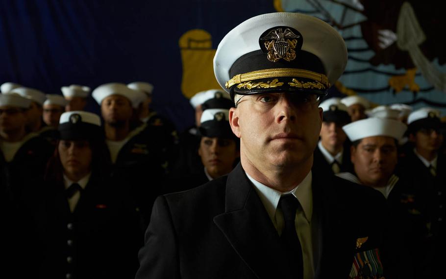 Sailors assigned to the nuclear-powered aircraft carrier USS Ronald Reagan stand in formation during a change-of-command ceremony aboard the warship, Tuesday, April 12, 2016, at Yokosuka Naval Base, Japan.