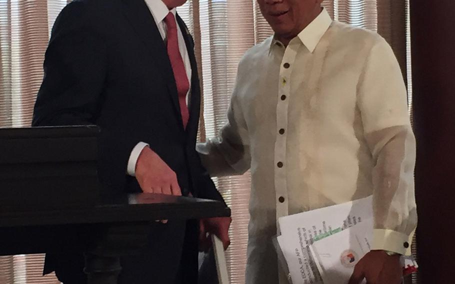 Defense Secretary Ash Carter speaks with Philippines defense minister Voltaire Gazmin after they announced on Thursday, April 14, 2016, that new rotational forces will operate out of the Philippines. 