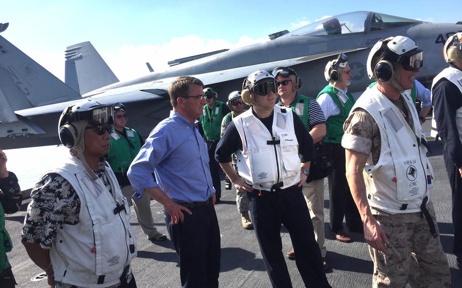 Philippines defense minister Voltaire Gazmin, far left, and U.S. Defense Secretary Ash Carter observe carrier launches of F/A-18 Super Hornets aboard the USS John C. Stennis during a sail through the South China Sea Friday, April 15, 2016. 

