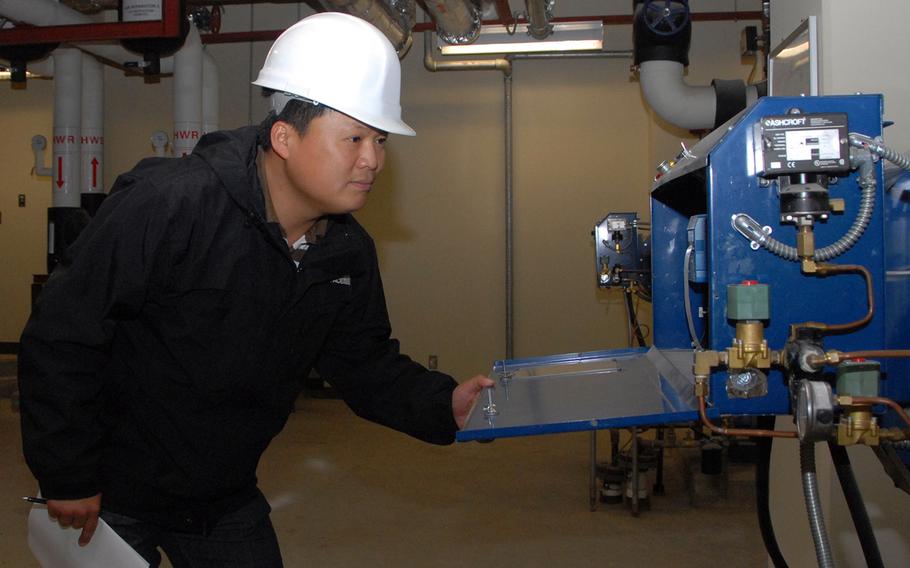 Kim Yong-Sik, then a U.S. Forces Korea employee, checks boiler room machinery at Kunsan Air Base, South Korea, Nov. 8, 2010. The U.S. recently eliminated a hardship differential allowance leading to a loss of income for nearly 3,000 Korea-based civilian employees.