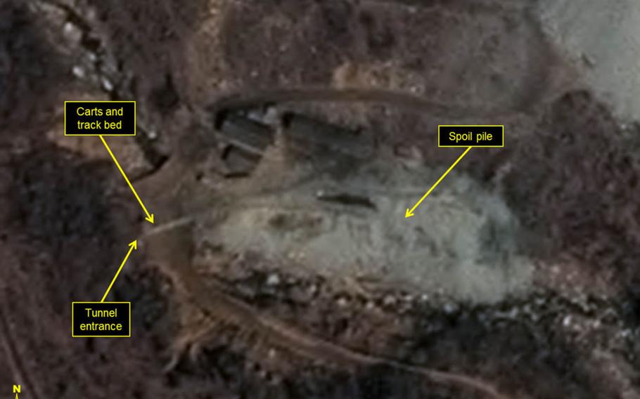 This satellite image taken Tuesday, April 19, 2016, shows what appear to be two small mine ore carts near a tunnel at the west portal of North Korea's Punggye-ri nuclear test site. The presence of the two carts crossing the track in the middle of the road and the absence of notable changes in the spoil pile suggests that tunnel excavation operations are about to resume, or have recently resumed, according to 38 North, a website that monitors North Korean activities.