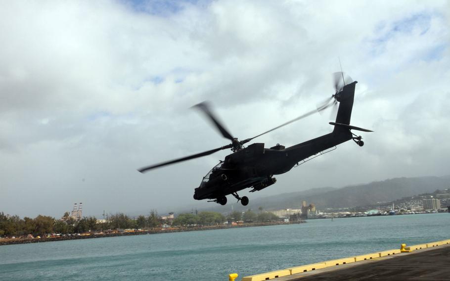 A maintenance crew readies a propeller on an Apache attack helicopter Sunday, April 24, 2016, in Honolulu, Hawaii. Two dozen Apaches are in Hawaii as part of the Army’s two-year aviation restructuring of the 25th Infantry Division.