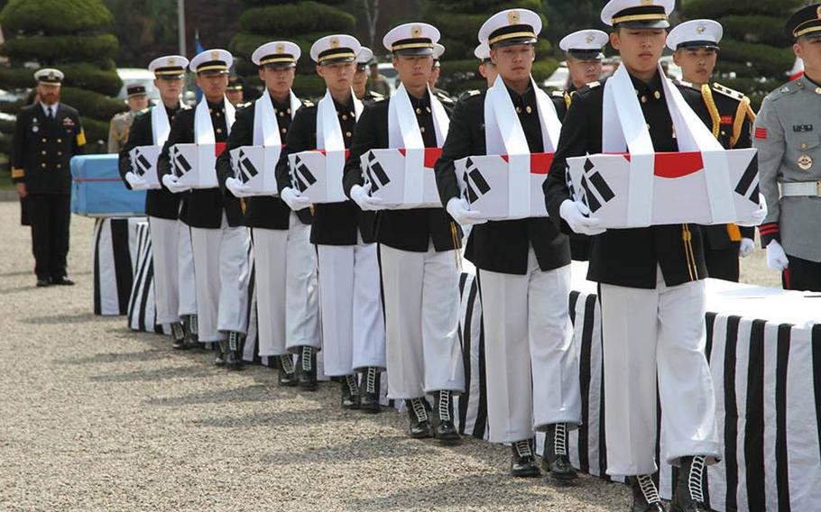 Pallbearers carry the remains of South Korean soldiers during a Korean War repatriation ceremony at U.S. Army Garrison-Yongsan, Thursday, April 28, 2016. 