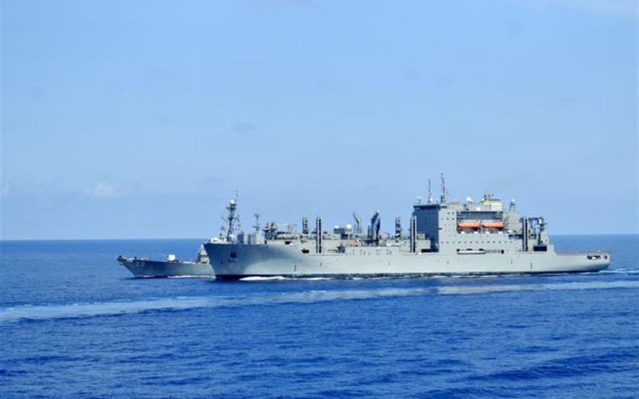 The guided-missile destroyer USS Russell conducts a replenishment at sea with the dry cargo and ammunition ship USNS Charles Drew in the South China Sea, March 10, 2016. 