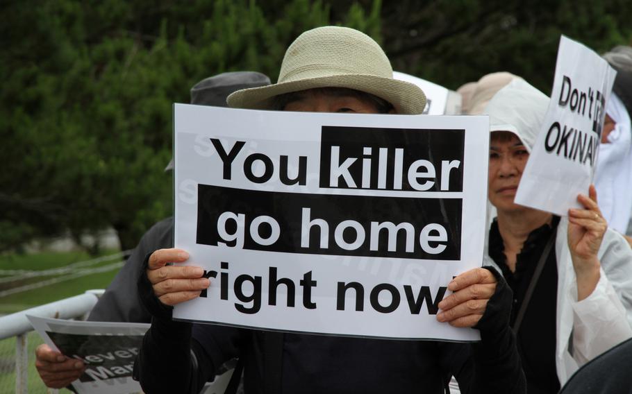 Approximately 2,000 protesters rallied in front of the gate at Marine Corps headquarters on Camp Foster Sunday to protest the U.S. military presence in Okinawa after a former U.S. Marine who worked as a civilian on Kadena Air Base confessed to the brutal slaying of a 20-year-old local woman. 