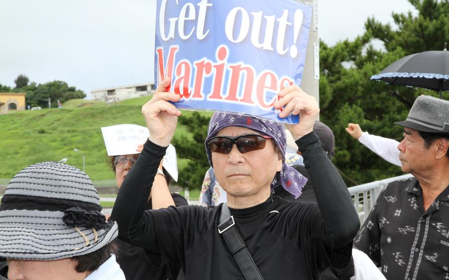 Approximately 2,000 protesters rallied in front of the gate at Marine Corps headquarters on Camp Foster Sunday to protest the U.S. military presence in Okinawa after a former U.S. Marine who worked as a civilian on Kadena Air Base confessed to the brutal slaying of a 20-year-old local woman. 