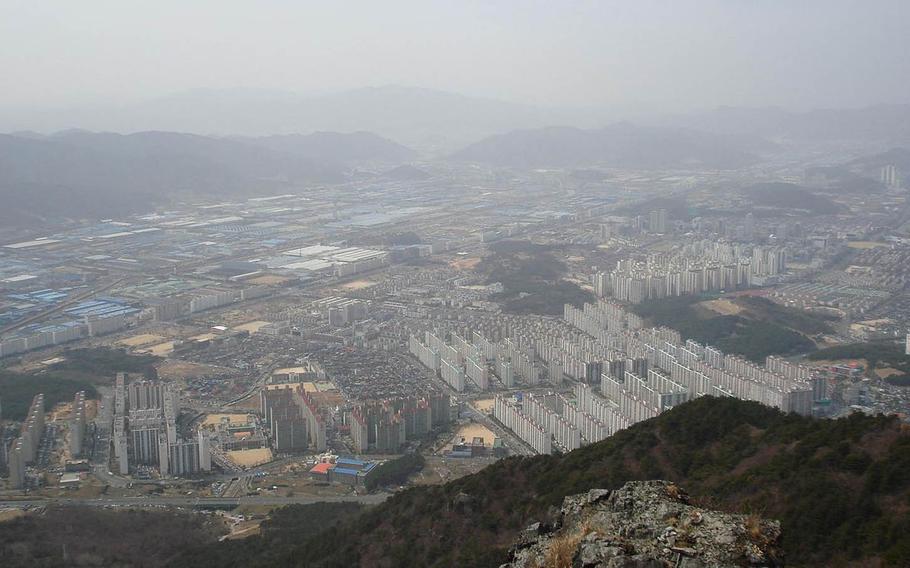 The city of Changwon, South Korea, is seen from atop a nearby mountain in 2008. A U.S. sailor died Sunday, May 22, 2016, after falling through an elevator shaft at a hotel in the southeastern city.