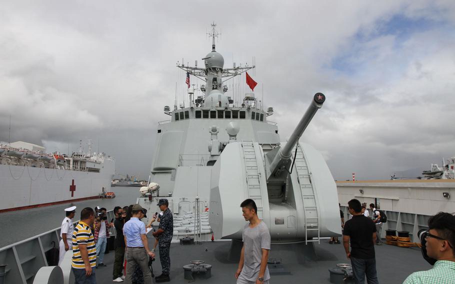 Reporters and other visitors gather to inspect the bow of the Haikou, China's flagship destroyer, during the 2014 Rim of the Pacific exercise in Hawaii.