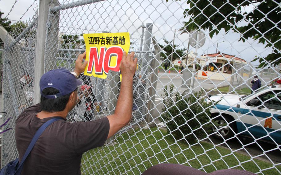 In this May 25, 2016, file photo, protesters rally in front of the gate at Marine Corps headquarters on Camp Foster on Sunday to protest the U.S. military presence in Okinawa after a former U.S. Marine who worked as a civilian on Kadena Air Base confessed to the brutal slaying of a 20-year-old local woman last month. 