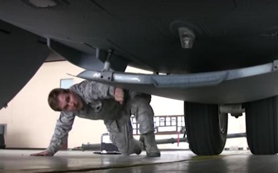 Air Force Staff Sgt. Charlie Carter-Wallot checks out a C-130 at Yokota Air Base.