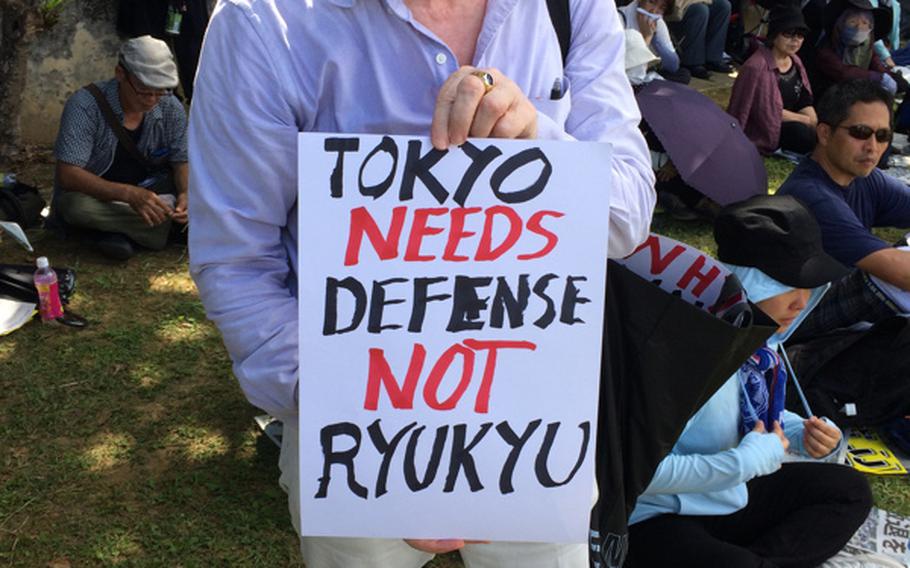 Bill O'Donnell, a 72-year-old former Navy petty officer 3rd class who lives on Okinawa after being stationed here in 1969-70, attended a protest Sunday, June 19, 2016, on Okinawa. O'Donnell who watched the speeches, ''We should go home. We should have gone home'' in 1972.


