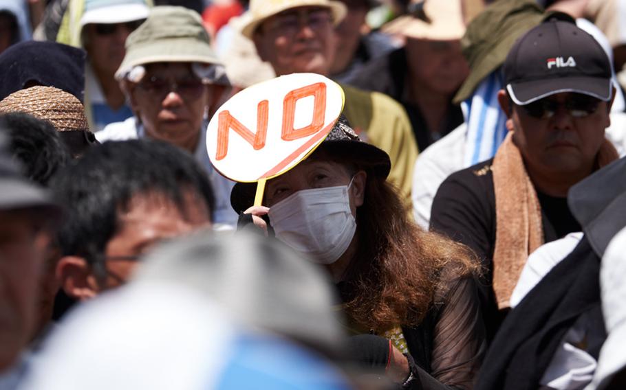 A protester holds up a sign expressing her desire to have no U.S. military bases during a rally in Okinawa June 19, 2016 in Naha, Japan, the capital city of Okinawa Prefecture. More than 40,000 protestoters withstood 90-plus degree weather for more than an hour to protest the U.S. presence.  

