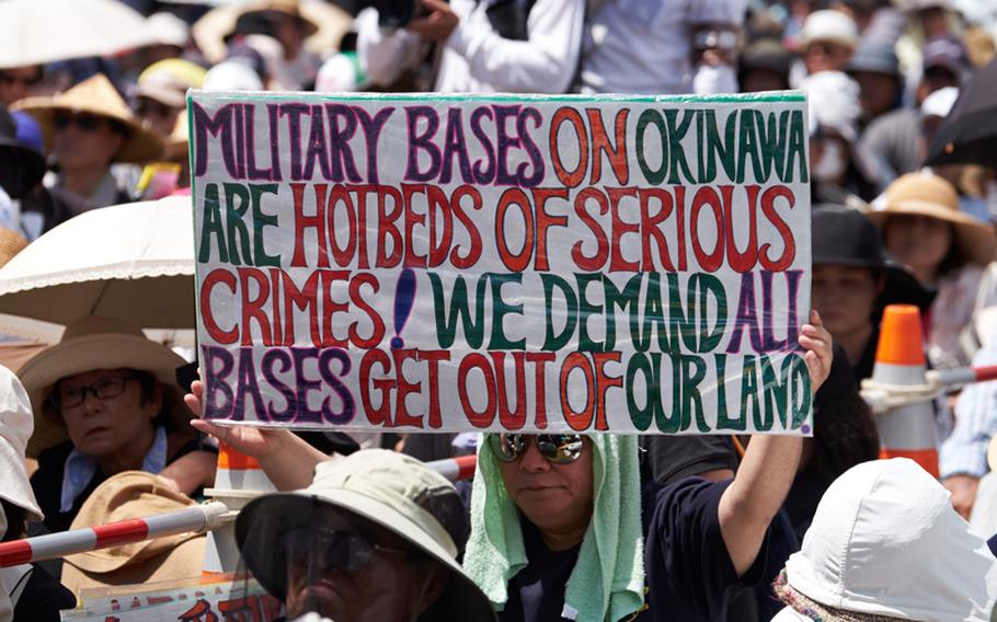 A protester holds up a sign demanding that U.S. military leave Okinawa during a rally June 19, 2016 in Naha, Japan, the capital city of Okinawa Prefecture.


