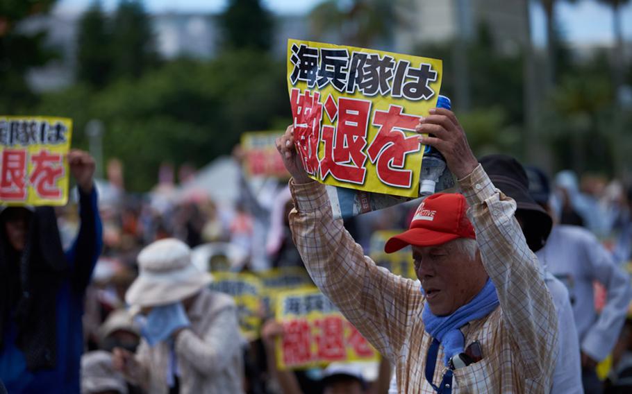 A protester holds up a sign translated into ''Withdraw Marines'' from Okinawa during a rally June 19, 2016 in Naha, Japan, the capital city of Okinawa Prefecture.
