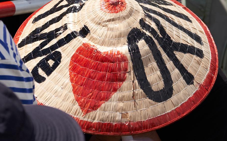 A protester wearing a reed hat reading ''We Love Okinawa,'' prays during an anti-U.S. military protest in Naha, Japan June 19, 2016. Officials stated 65,000 protestors attended the rally demanding the withdraw of U.S. forces from the island prefecture.  
