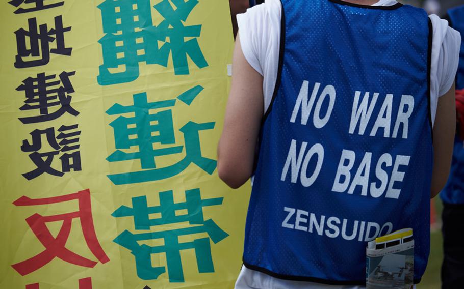 A protester wears a vest voicing his opinion of the U.S. military, Japan June 19, 2016. Officials said 65,000 people attended the protest to demand U.S. Marines leave the island.

