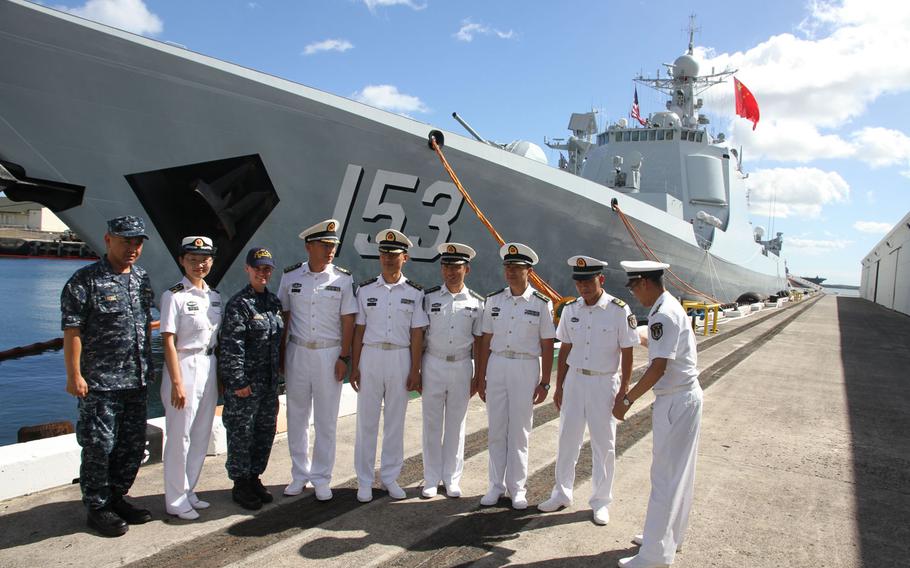 Officers from the five Chinese ships attending the Rim of the Pacific exercise line up in front of the guided-missile destroyer Xian for a group photo July 8, 2016, at Joint Base Pearl Harbor-Hickam, Hawaii. They are joined by two U.S. Navy officers who acted as translators for visiting reporters.
