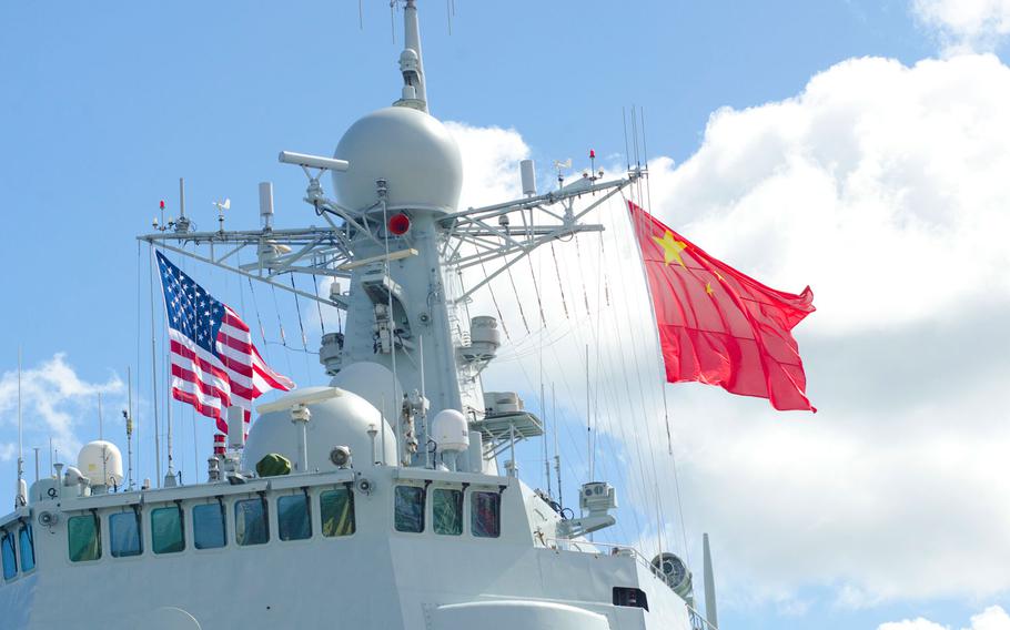 The flags of China and the United States wave above helm of China's guided-missile destroyer Xian July 8, 2016, while the ship was docked at Joint Base Pearl Harbor-Hickam, Hawaii, July 8, 2016, for the Rim of the Pacific exercise.