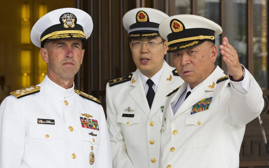 U.S. Chief of Naval Operations Adm. John Richardson listens to Commander of the Chinese Navy Adm. Wu Shengli, right, at the Chinese navy's headquarters in Beijing on Monday, July 18, 2016. Richardson said friendly exchanges with China's navy are conditional on safe and professional interactions at sea. His comments, made Wednesday, July 20, 2016, follow several fractious encounters between the two sides' ships and planes in and over the disputed South China Sea.