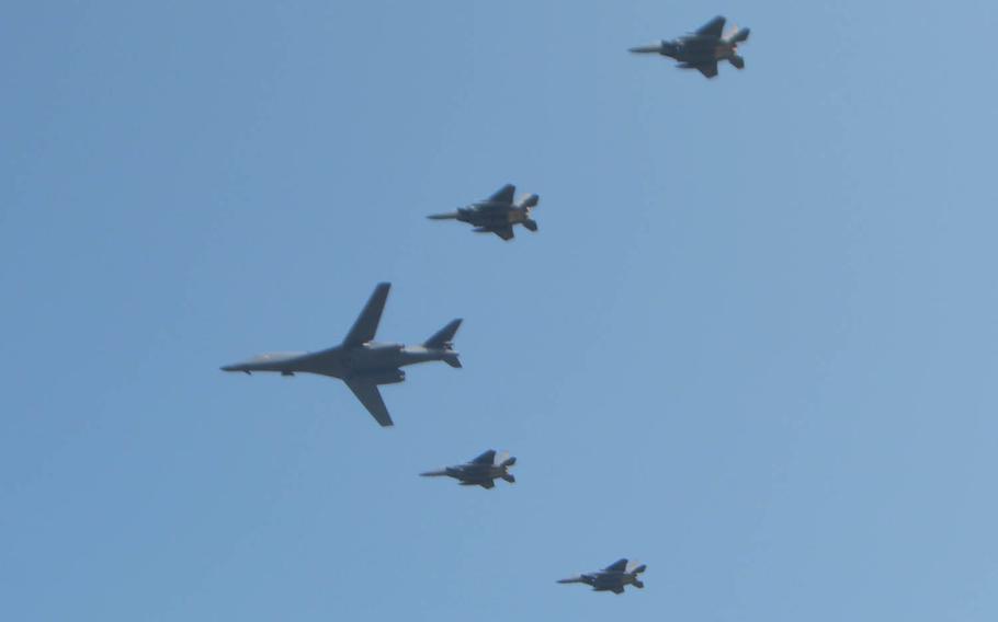 A B-1B Lancer bomber, flanked by four fighter jets, flies over Osan Air Base, South Korea, Tuesday, Sept. 13, 2016. The show of force came four days after North Korea conducted its fifth and most powerful nuclear test. 