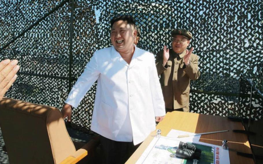 North Korean leader Kim Jong Un receives applause after an apparently successful test of a rocket engine in this photo published in the Tuesday, Sept. 20, 2016, edition of the official Rodong Sinmun newspaper.