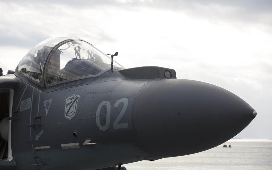 An AV-8B Harrier sits on the flight deck of the USS Bonhomme Richard as it pulls out of port at White Beach, Okinawa, Japan, in February 2016. A pilot ejected safely after a U.S. Marine Corps Harrier jet crashed into the ocean off Okinawa on Thursday, Sept. 22, 2016. 