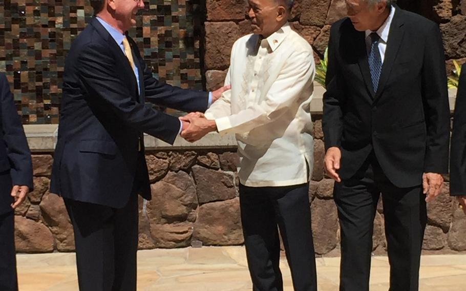 Secretary of Defense Ash Carter shakes hands Friday with his Philippine counterpart Delfin Lorenzana during a meeting of Southeast Asian defense ministers. 