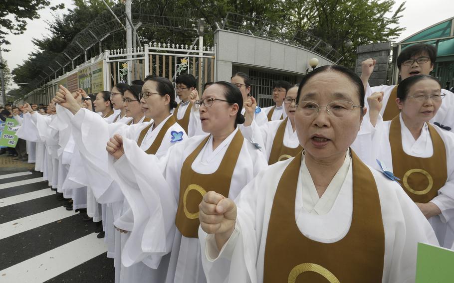 South Korean Won Buddhism monks shout slogans during a rally to oppose a deployment of the Terminal High-Altitude Area Defense, or THAAD, in front of the Defense ministry in Seoul, South Korea, Friday, Sept. 30, 2016.