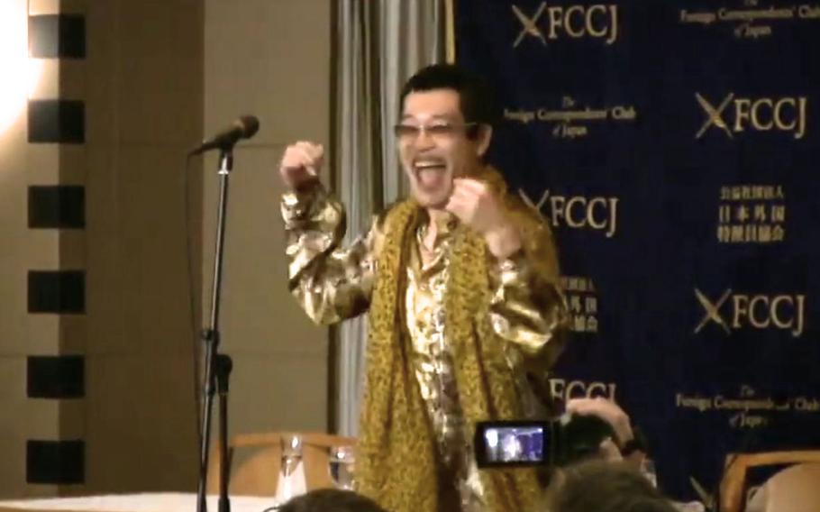 A video screen grab shows Pikotaro singing his YouTube hit song Pen-Pineapple-Apple-Pen song.