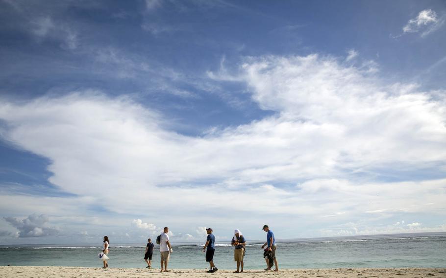 Servicemembers help clean up a beach at Andersen Air Force Base, Guam, in September. A search-and-rescue operation was underway Tuesday, Nov. 22, 2016, after an airman went missing while swimming at Tarague Beach on the air base.