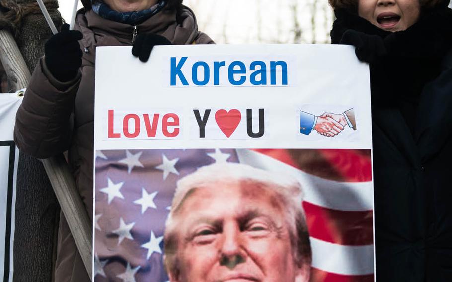 South Korean supporters of President Donald Trump welcome Secretary of Defense Jim Mattis to South Korea, Friday, Feb. 3, 2017. 